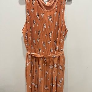 Coral floral dress with pleated skirt and sash. Worn once. Perfect for summer!